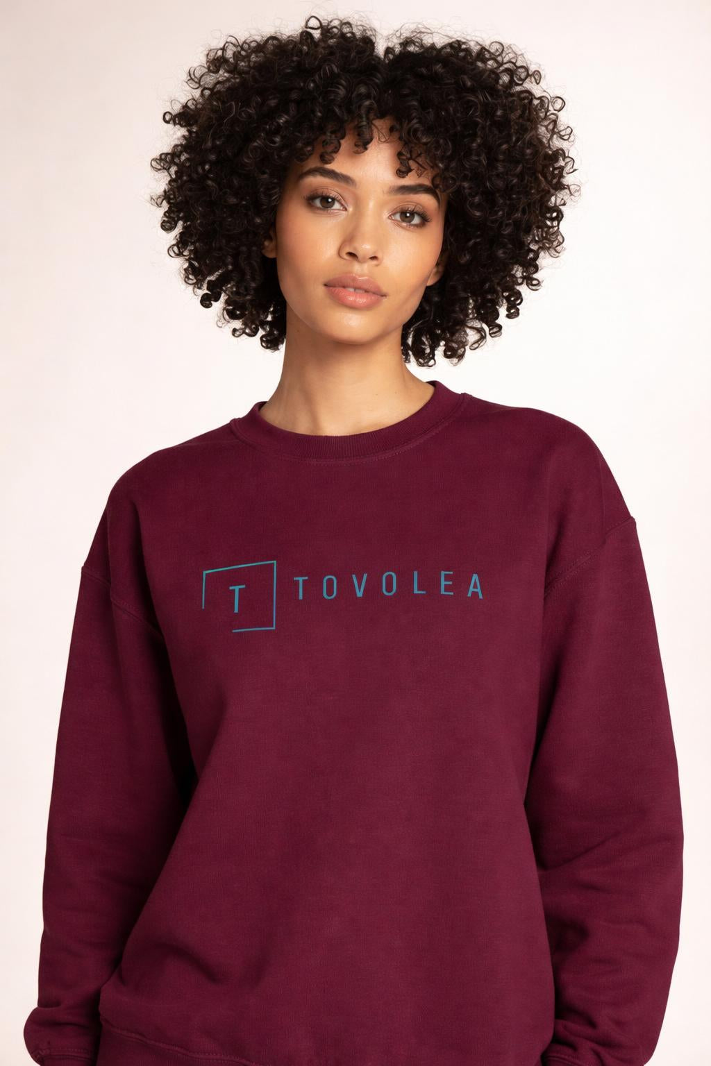 Close-up of the model wearing Tovolea Ladies Maroon Crewneck Sweatshirt