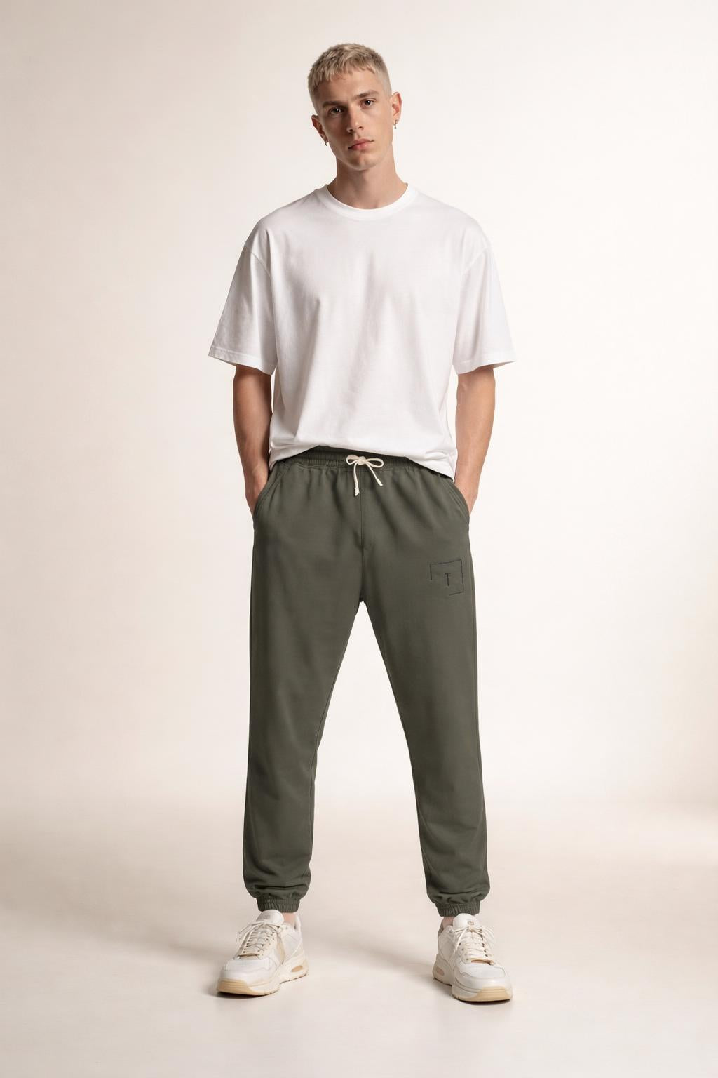 Full body view of the model wearing Tovolea Gents Grey Embroidered Fleece Sweatpants