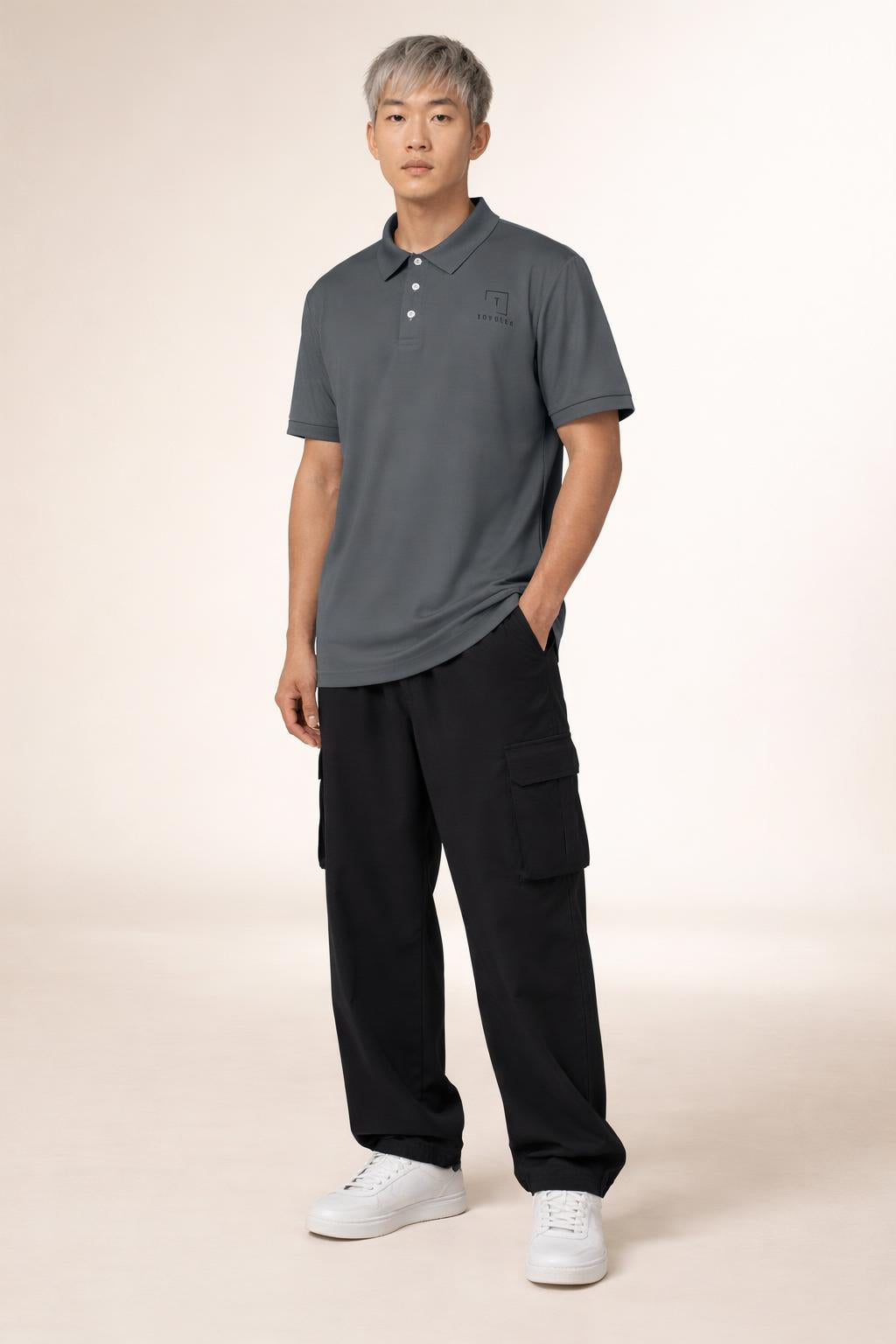 Full body view of the model wearing Tovolea Gents Dark Grey Polo Shirt