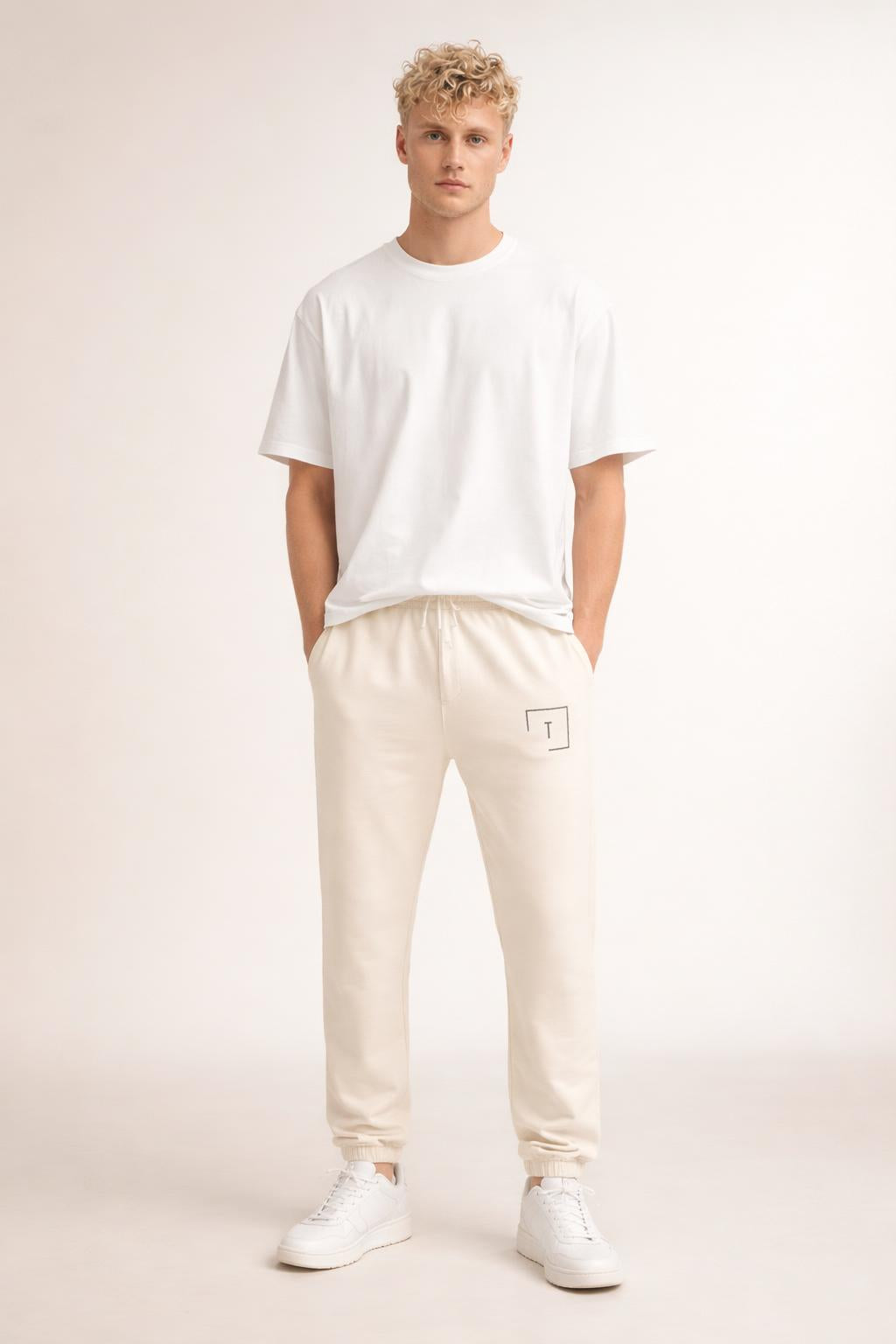 Full body view of the model wearing Tovolea Gents Ivory Embroidered Fleece Sweatpants