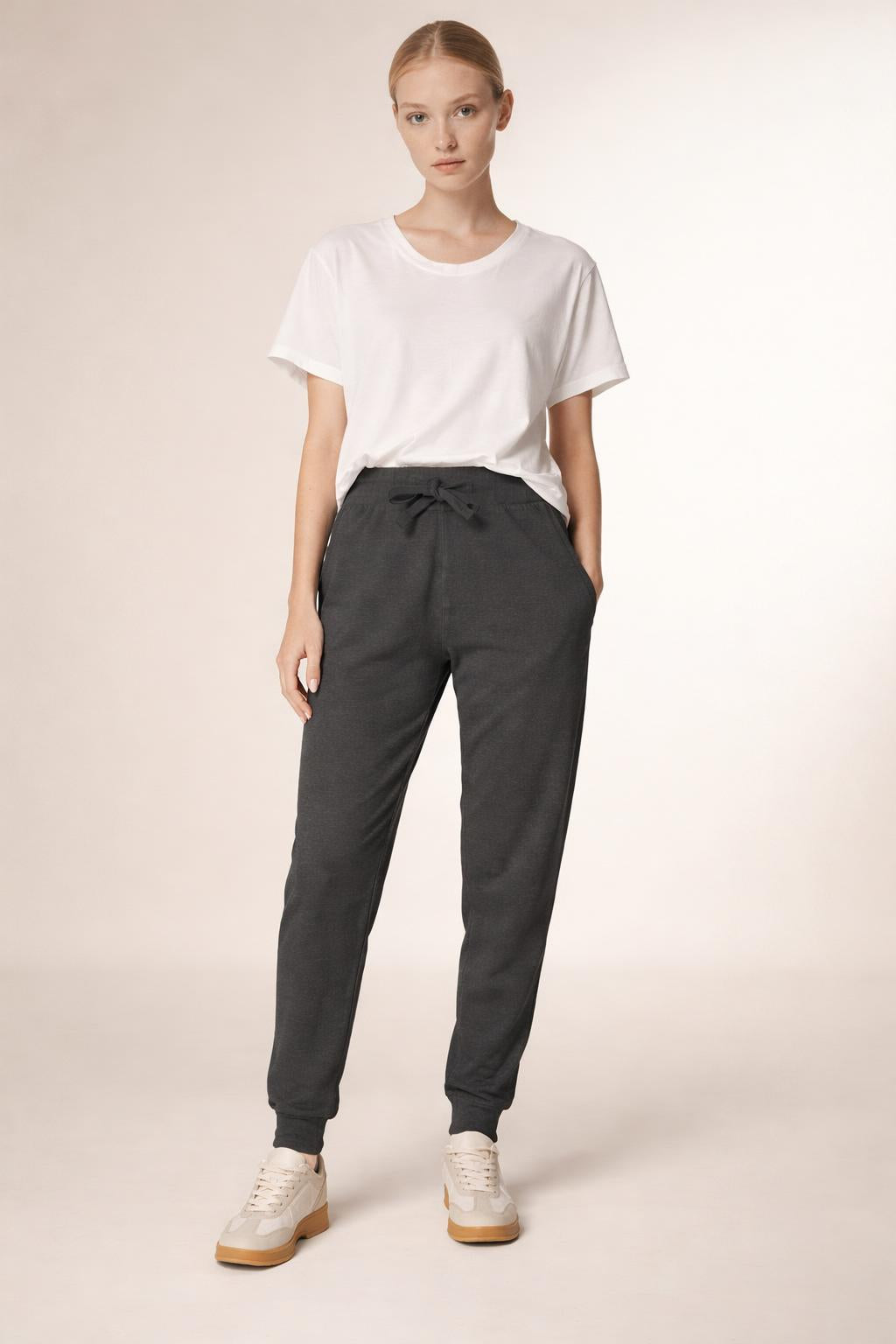 Full body view of the model wearing Tovolea Embroidered Black Fleece Sweatpants