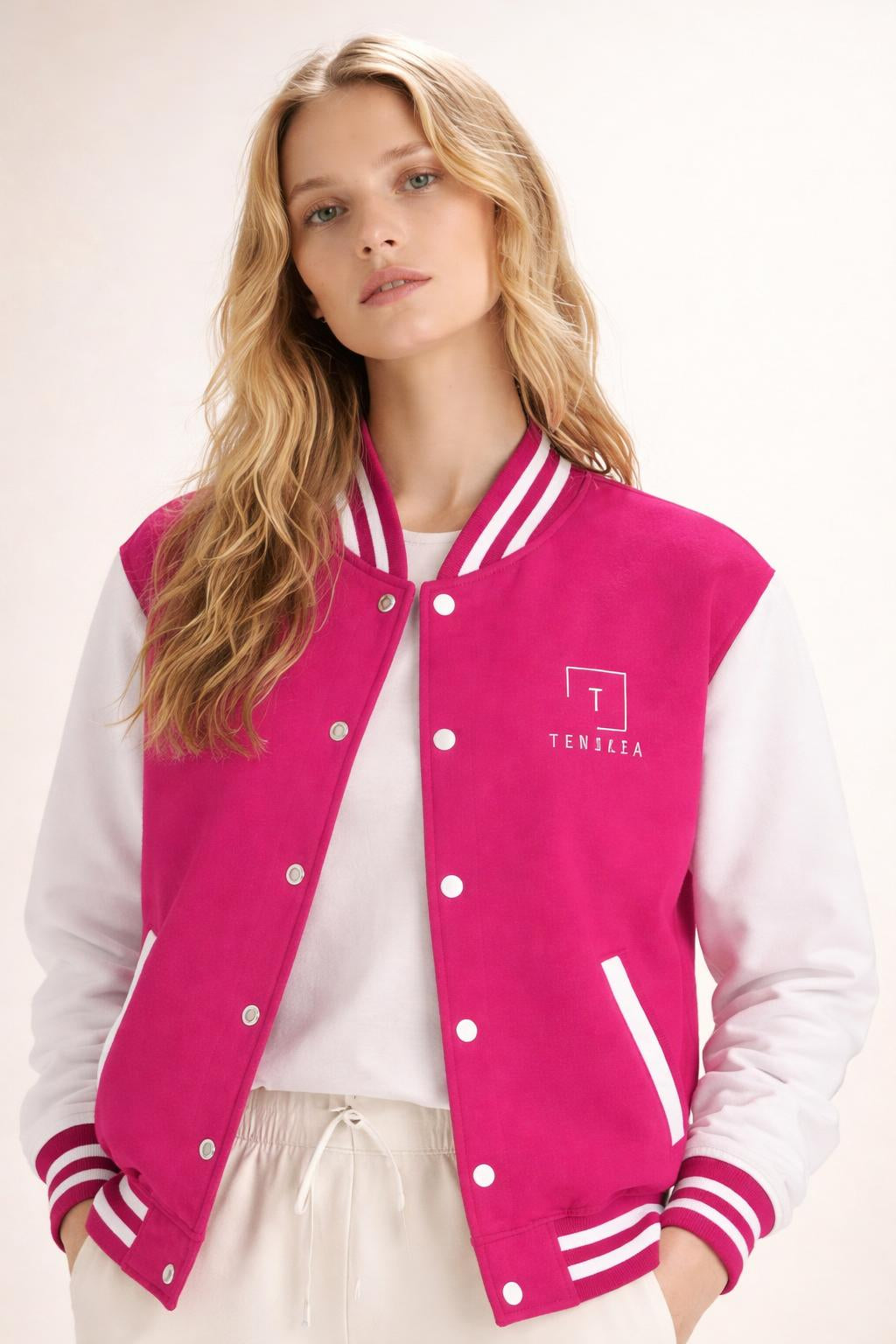 Close-up of the model wearing Tovolea Ladies Classic Pink & White Letterman Jacket