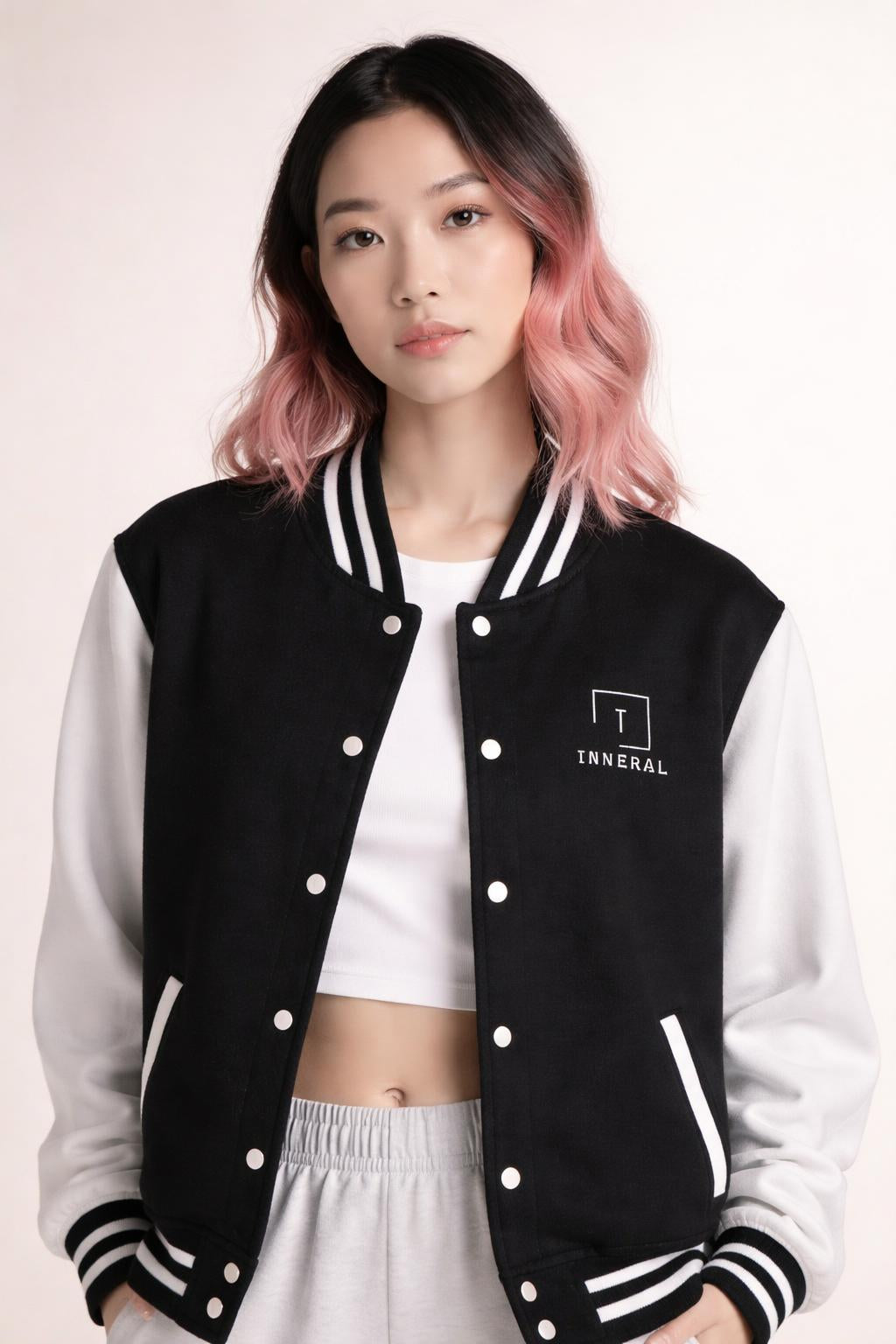 Close-up of the model wearing Tovolea Ladies Classic Black & White Letterman Jacket