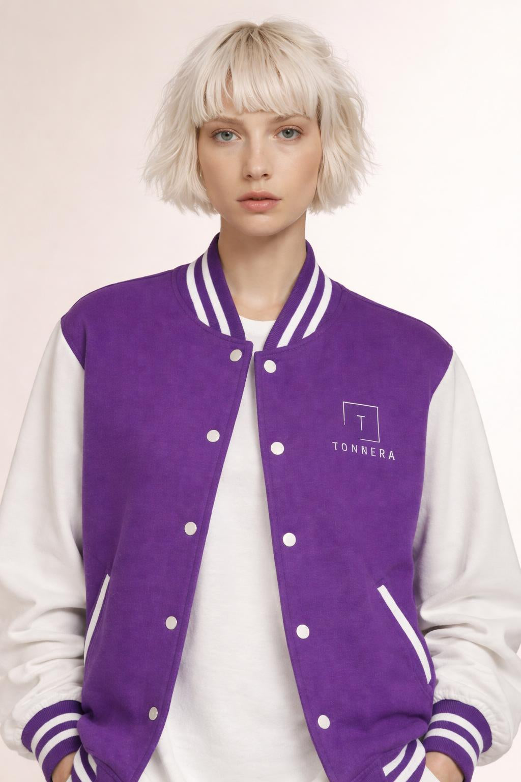 Close-up of the model wearing Tovolea Ladies Classic Purple & White Letterman Jacket