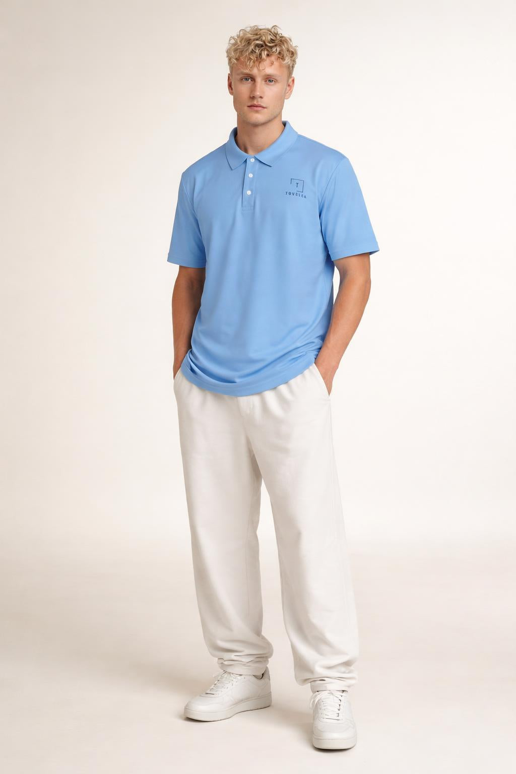 Full body view of the model wearing Tovolea Gents Light Blue Polo Shirt